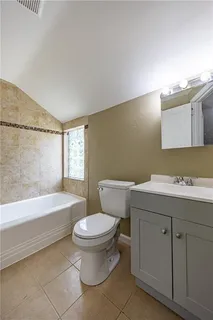 a bathroom with a sink a toilet and bathtub