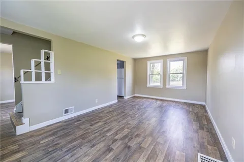 a view of an empty room with windows