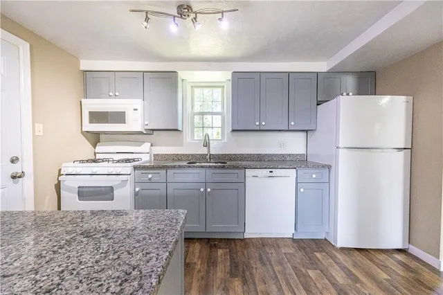 a kitchen with a refrigerator stove and sink