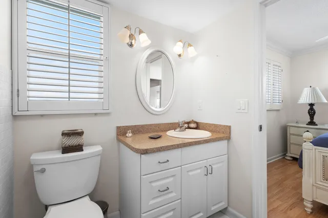 a bathroom with a toilet a sink and a mirror