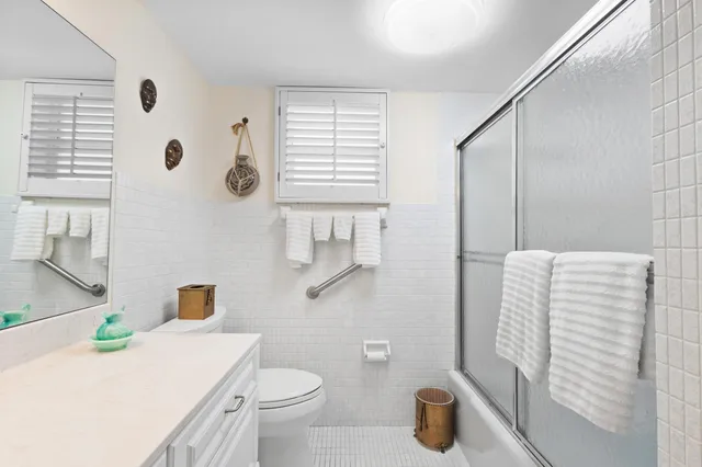 a bathroom with a sink a toilet and a shower