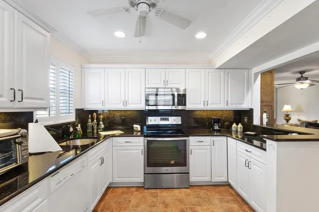 a kitchen with a sink stove and cabinets