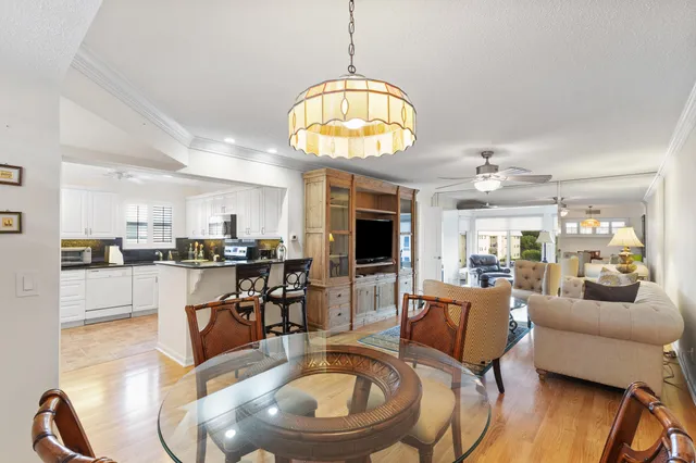 a living room with furniture a dining table and a chandelier