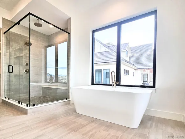 a view of a bathroom with a tub and windows