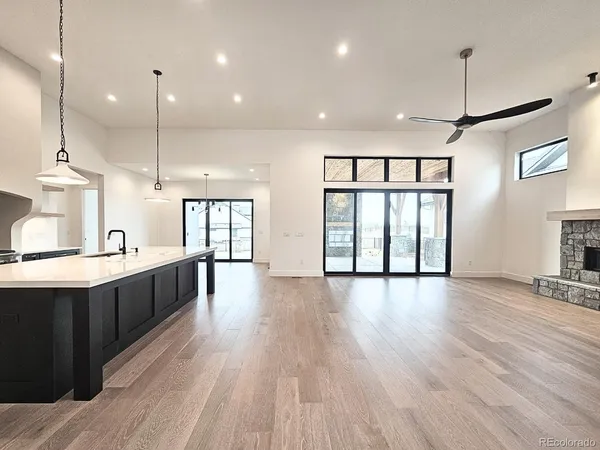 a large kitchen with lots of counter space a sink appliances and a large window