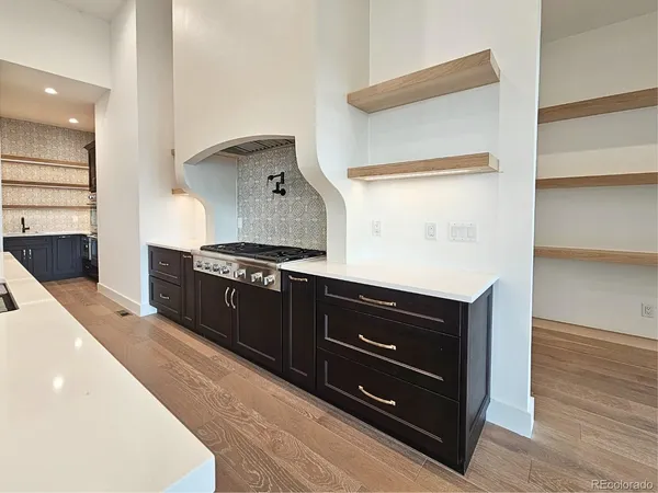 a kitchen with stainless steel appliances a stove and a refrigerator