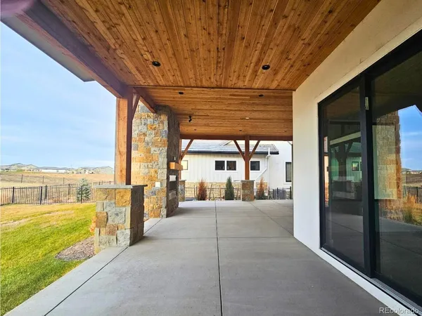 a view of a patio with a table and chairs
