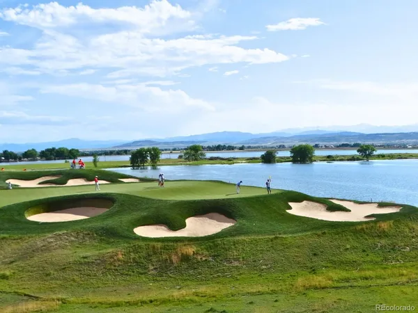 a view of a lake with houses in the back
