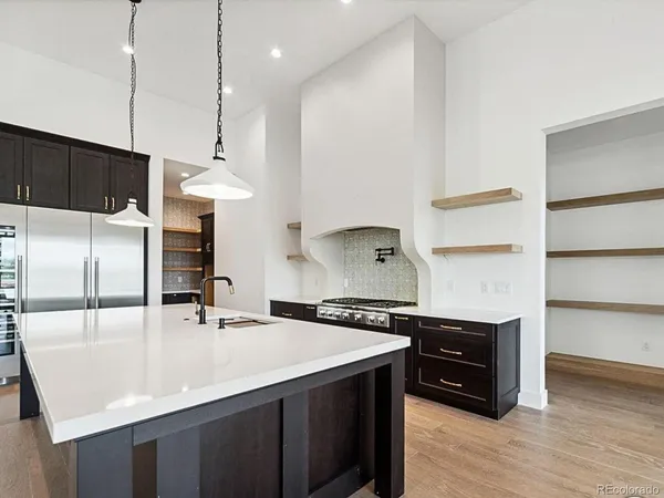 a kitchen with kitchen island a sink stainless steel appliances and cabinets