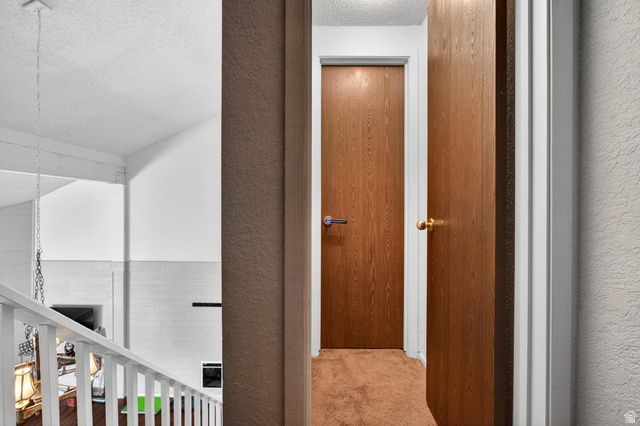 407 South Vasels Road, Unit 24 Brian Head, UT 84719 - Photo 25 of 63 Hall with a textured ceiling, a textured wall, and carpet floors