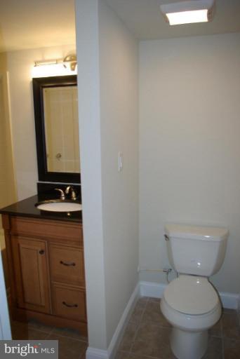 4676 Marble Hall Road Baltimore, MD 21239 - Photo 17 of 20 a white toilet sitting next to a bathroom sink