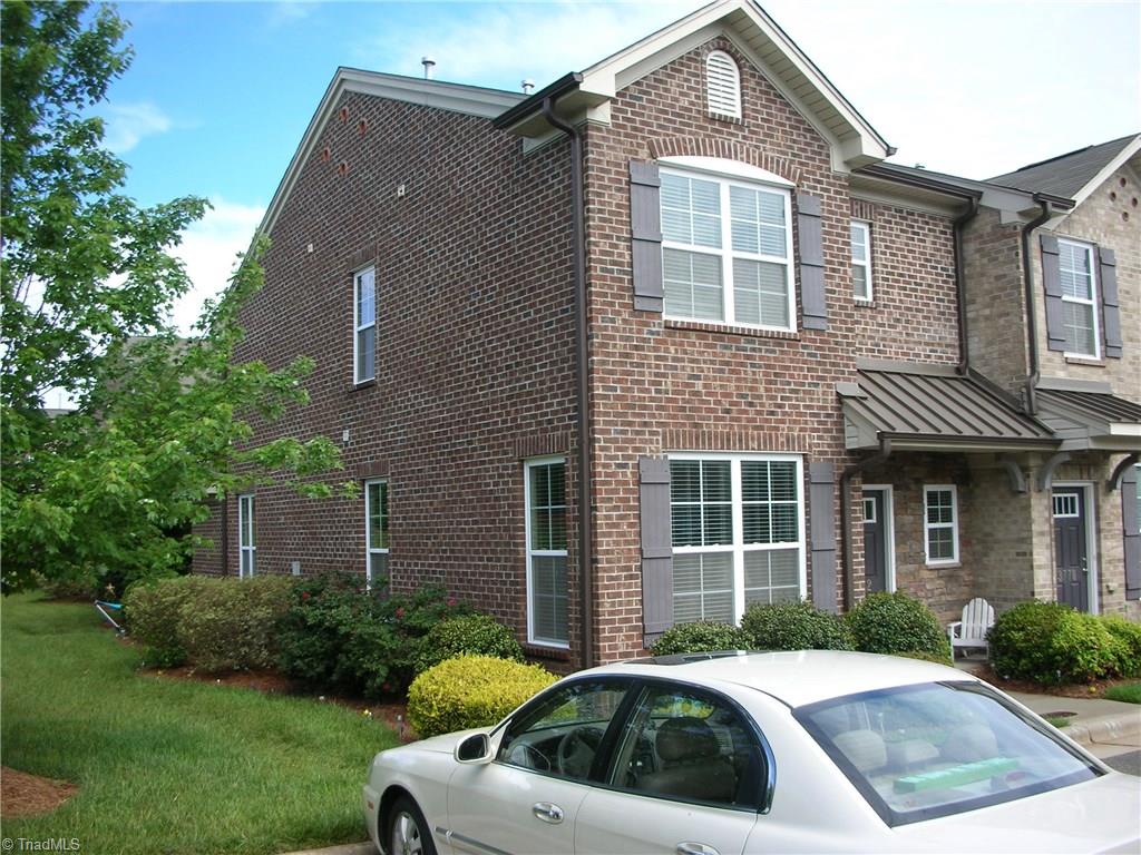 3772 Shadow Ridge Drive High Point, NC 27265 - Photo 2 of 27 Side view of home showing side yard with grass and landscaping.