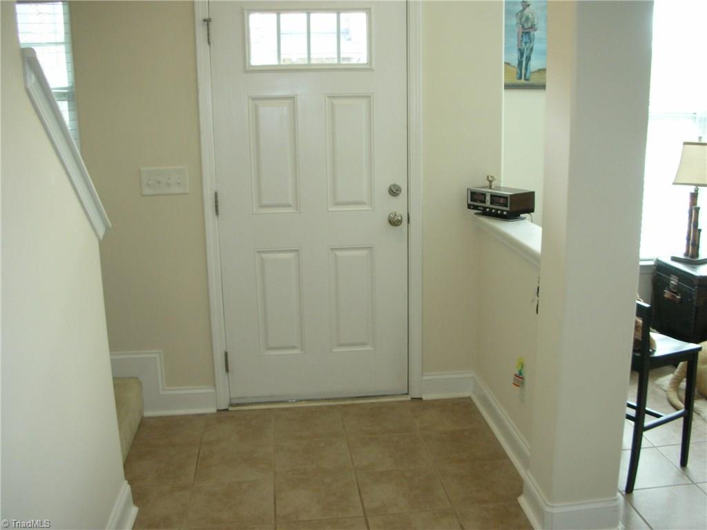 3772 Shadow Ridge Drive High Point, NC 27265 - Photo 3 of 27 Front door entryway. Stairs to upper level on left and living room on the right. Divider wall shown between living room and front door.