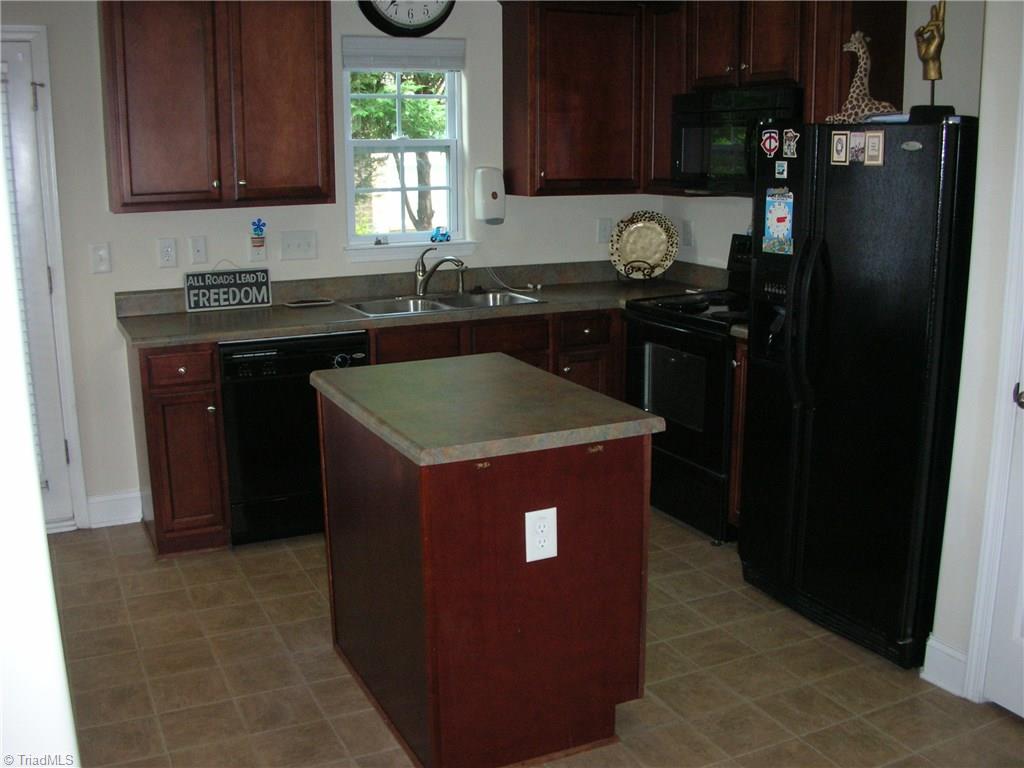 3772 Shadow Ridge Drive High Point, NC 27265 - Photo 6 of 27 The kitchen comes equipped with a dishwasher, slide in stove, refrigerator and a garbage disposal. You also have a kitchen island which is very convenient during meal preparation and notice the window over the sink so that you can enjoy the backyard while you are cleaning up some of those dishes after the party.