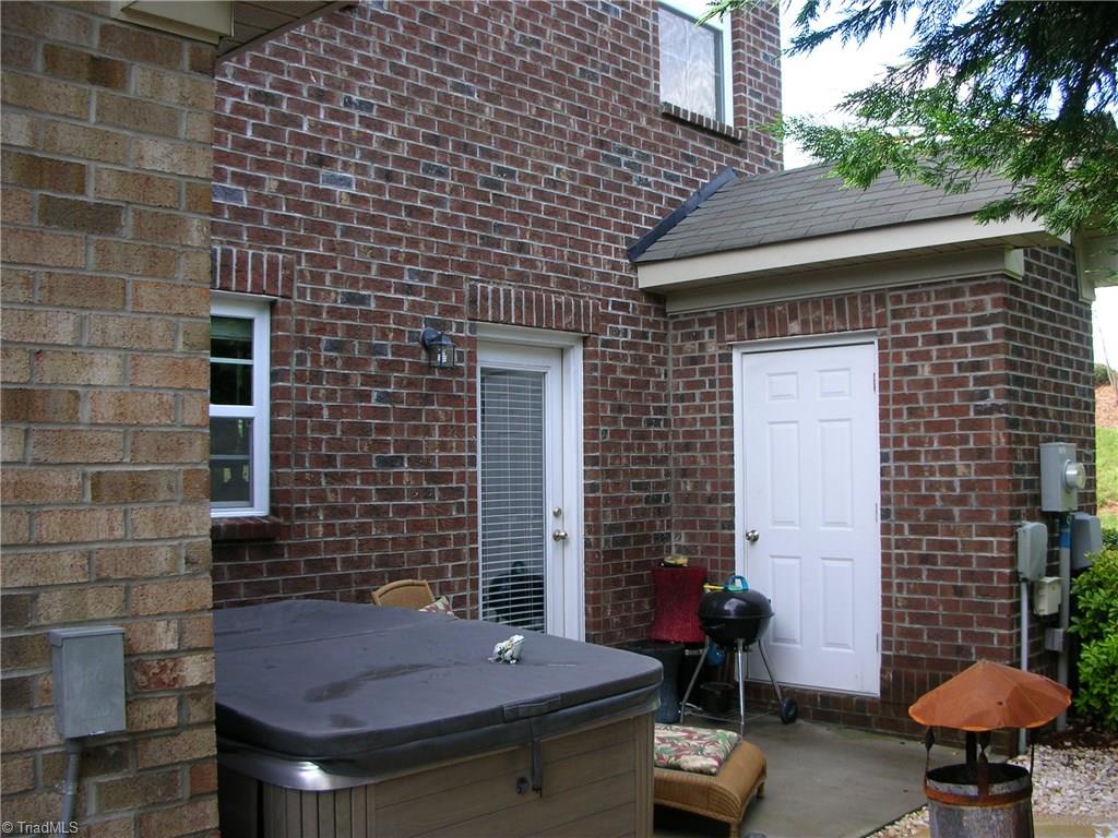 3772 Shadow Ridge Drive High Point, NC 27265 - Photo 10 of 27 Rear view of home shows storage area to the right and entry door into the kitchen area. Partial view shows concrete patio approx. 7ft x 15ft.