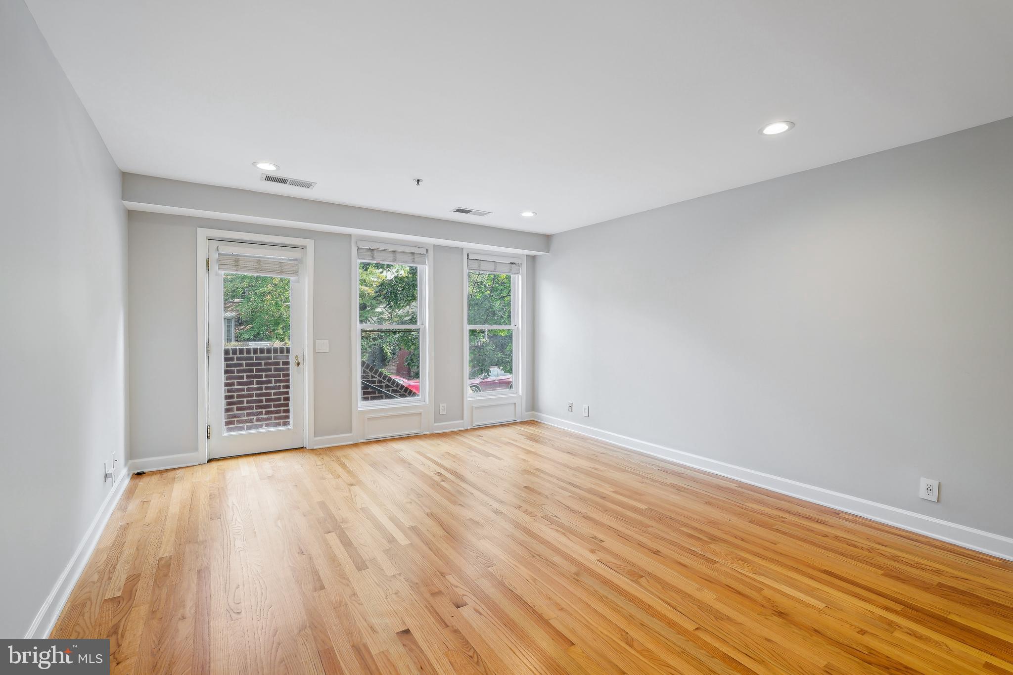 110 Cameron Street, Unit CS103 Alexandria, VA 22314 - Photo 6 of 16 Living room and door to Cameron Street