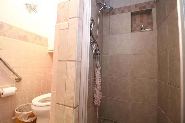 a bathroom with a toilet and shower