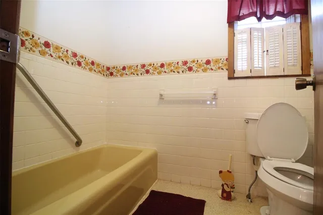 a bathroom with a bathtub and a toilet