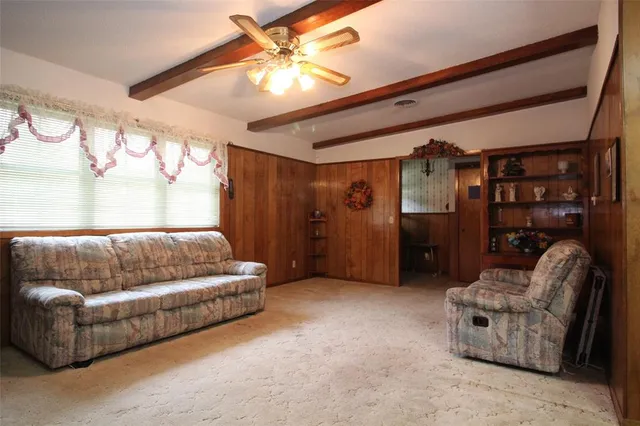 a living room with furniture and a ceiling fan