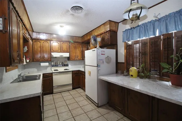 a kitchen with sink cabinets and window
