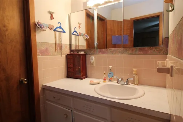 a bathroom with a sink and a mirror