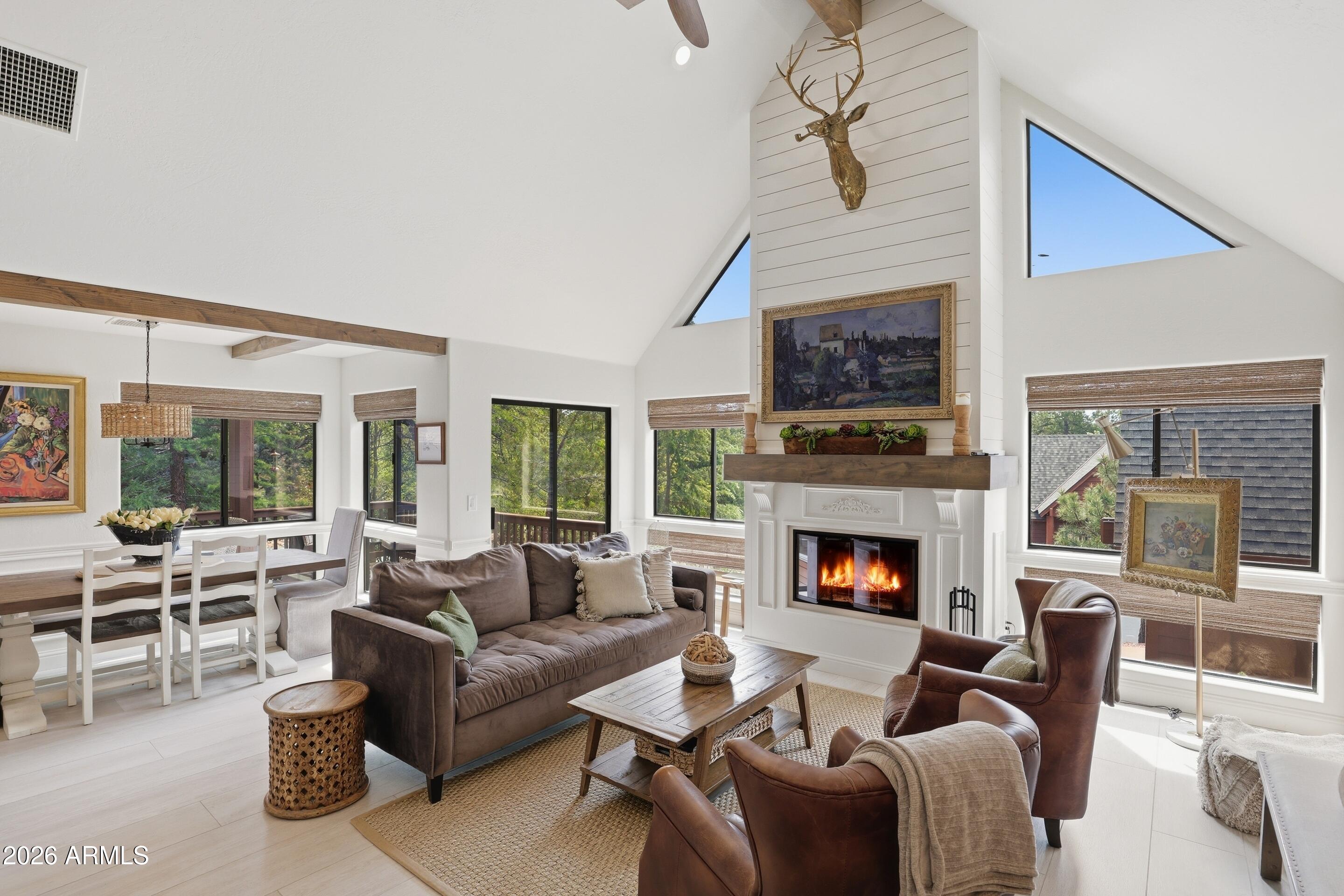 2502 East Elk Run Court Payson, AZ 85541 - Photo 1 of 27 a living room with furniture a fireplace and a flat screen tv