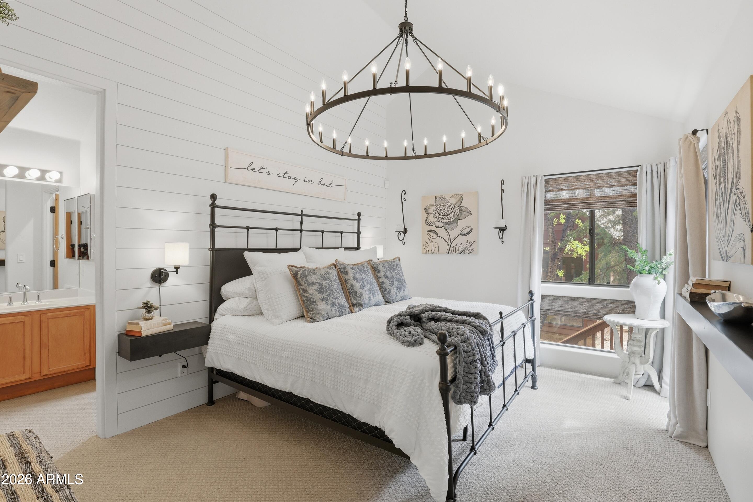 2502 East Elk Run Court Payson, AZ 85541 - Photo 13 of 27 a bed room with a bed and a chandelier