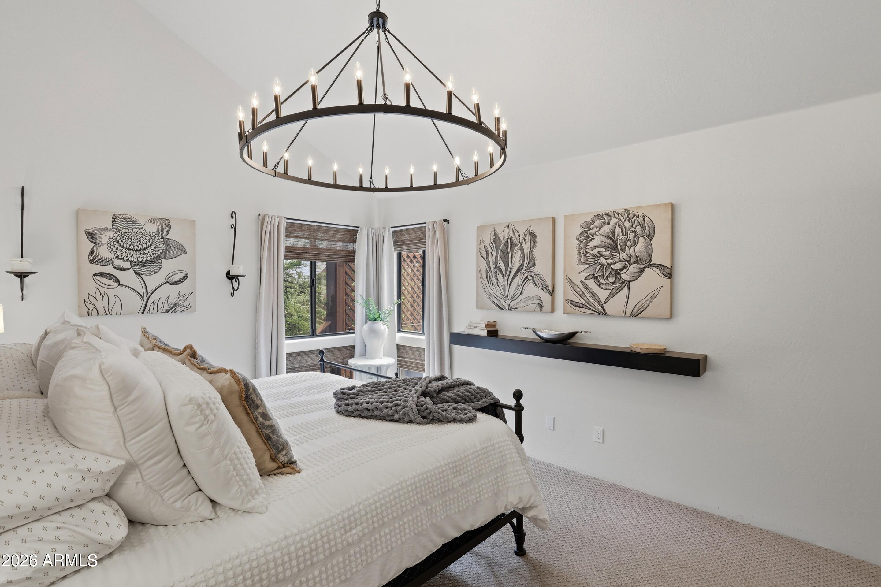 2502 East Elk Run Court Payson, AZ 85541 - Photo 14 of 27 a bedroom with a bed and a chandelier