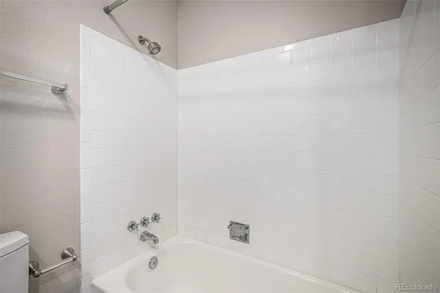 a bathroom with a white bath tub and a shower
