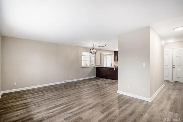a view of wooden floor and windows in a room