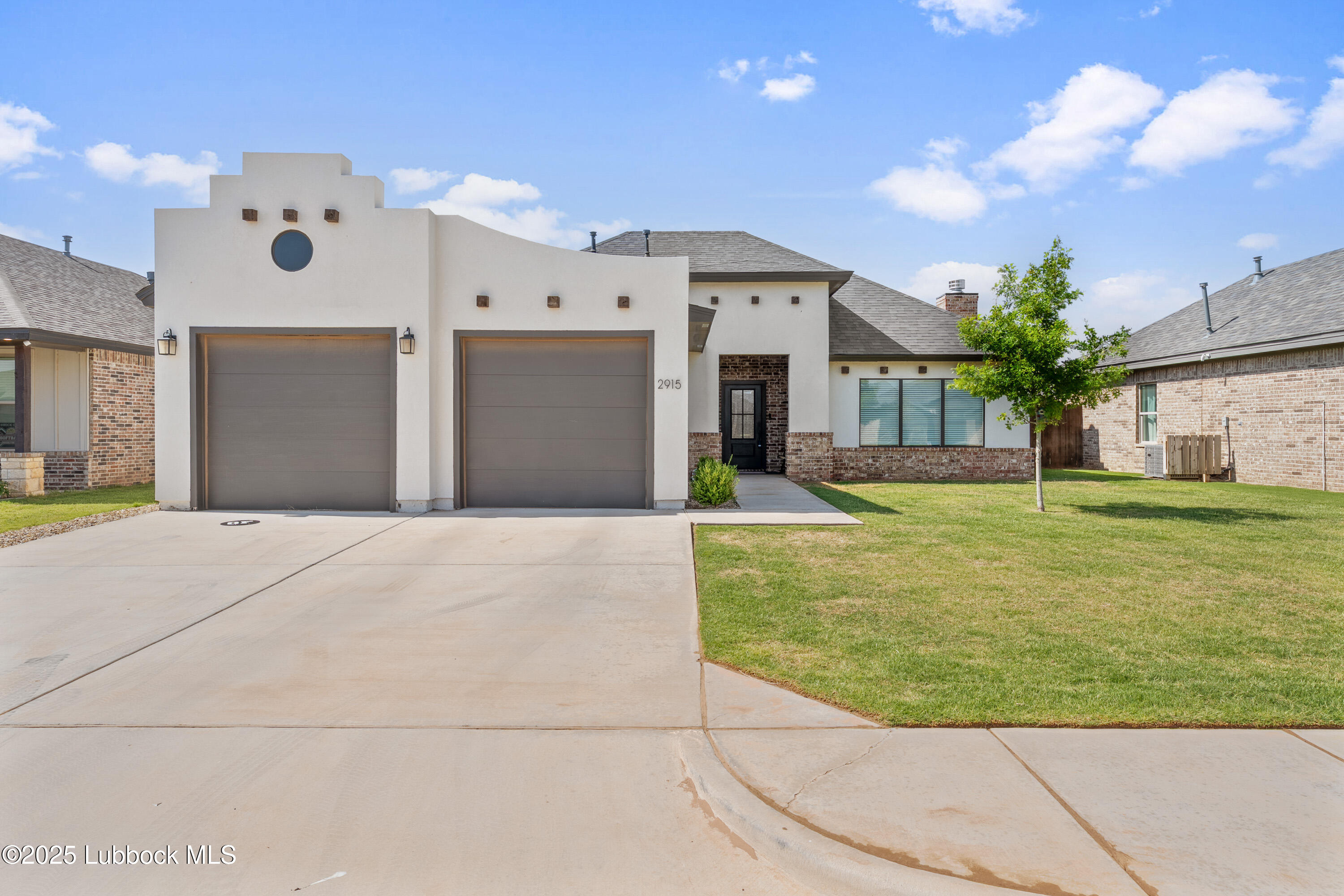 2915 137th Street Lubbock, TX 79423 - Photo 1 of 40 a front view of a house with garden