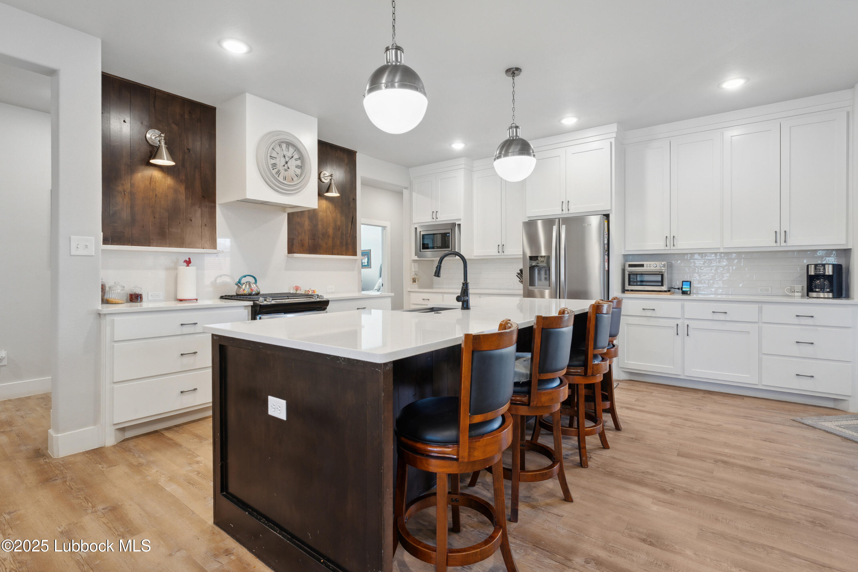 2915 137th Street Lubbock, TX 79423 - Photo 15 of 40 a kitchen with a table chairs sink and cabinets