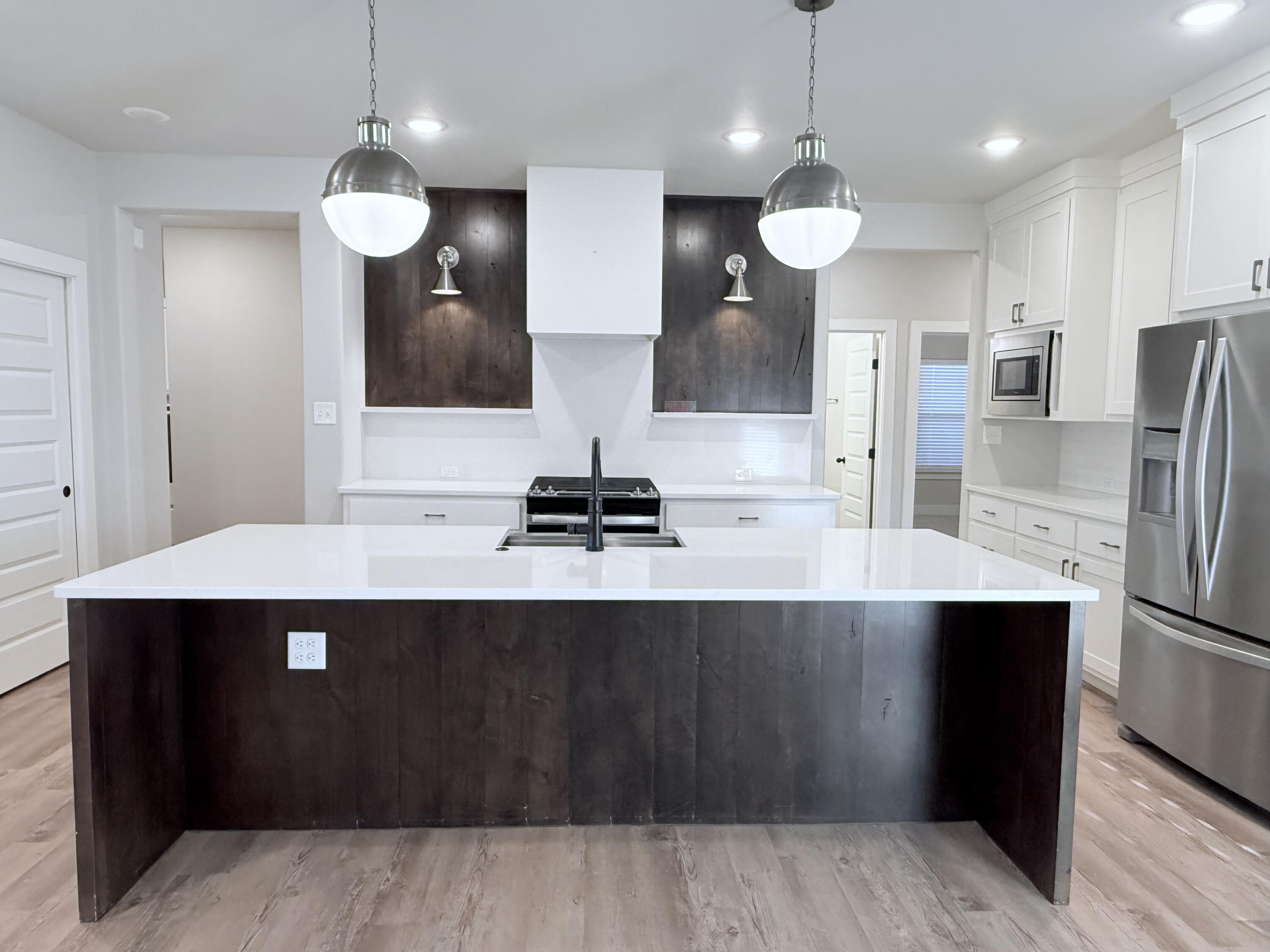 2915 137th Street Lubbock, TX 79423 - Photo 20 of 40 a large kitchen with a sink and stainless steel appliances