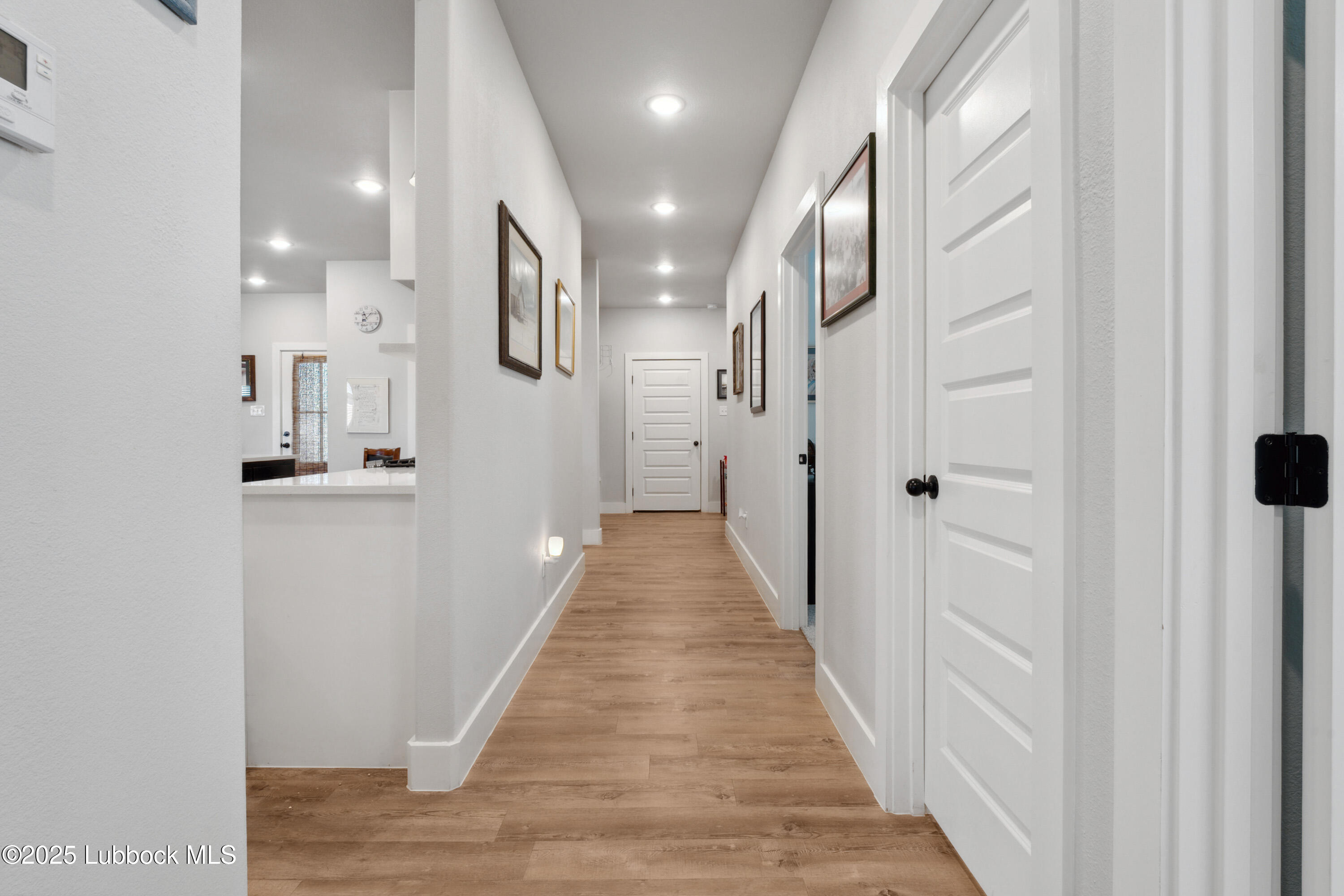 2915 137th Street Lubbock, TX 79423 - Photo 24 of 40 a view of a hallway with wooden floor and staircase