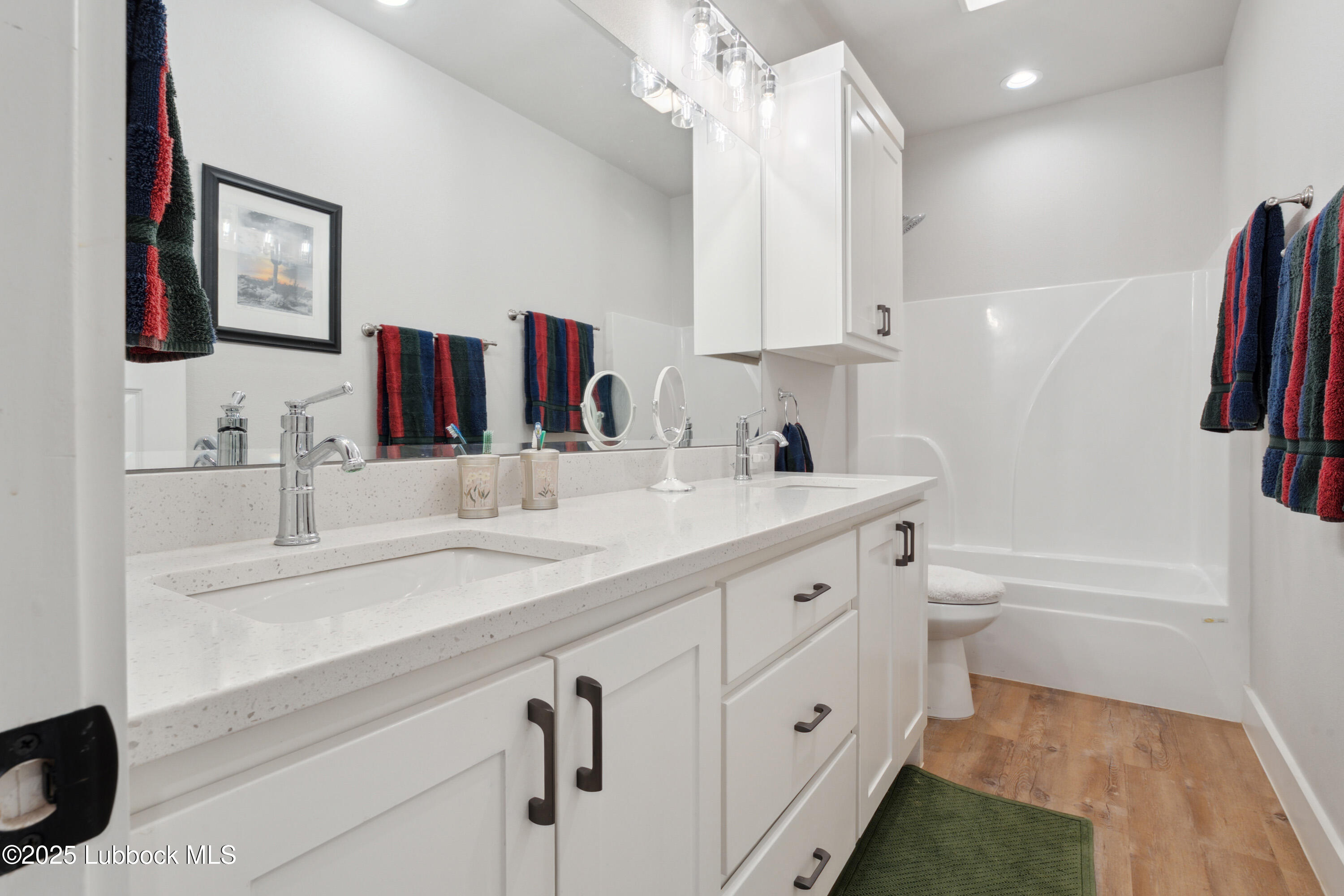 2915 137th Street Lubbock, TX 79423 - Photo 26 of 40 a bathroom with a tub sink and mirror