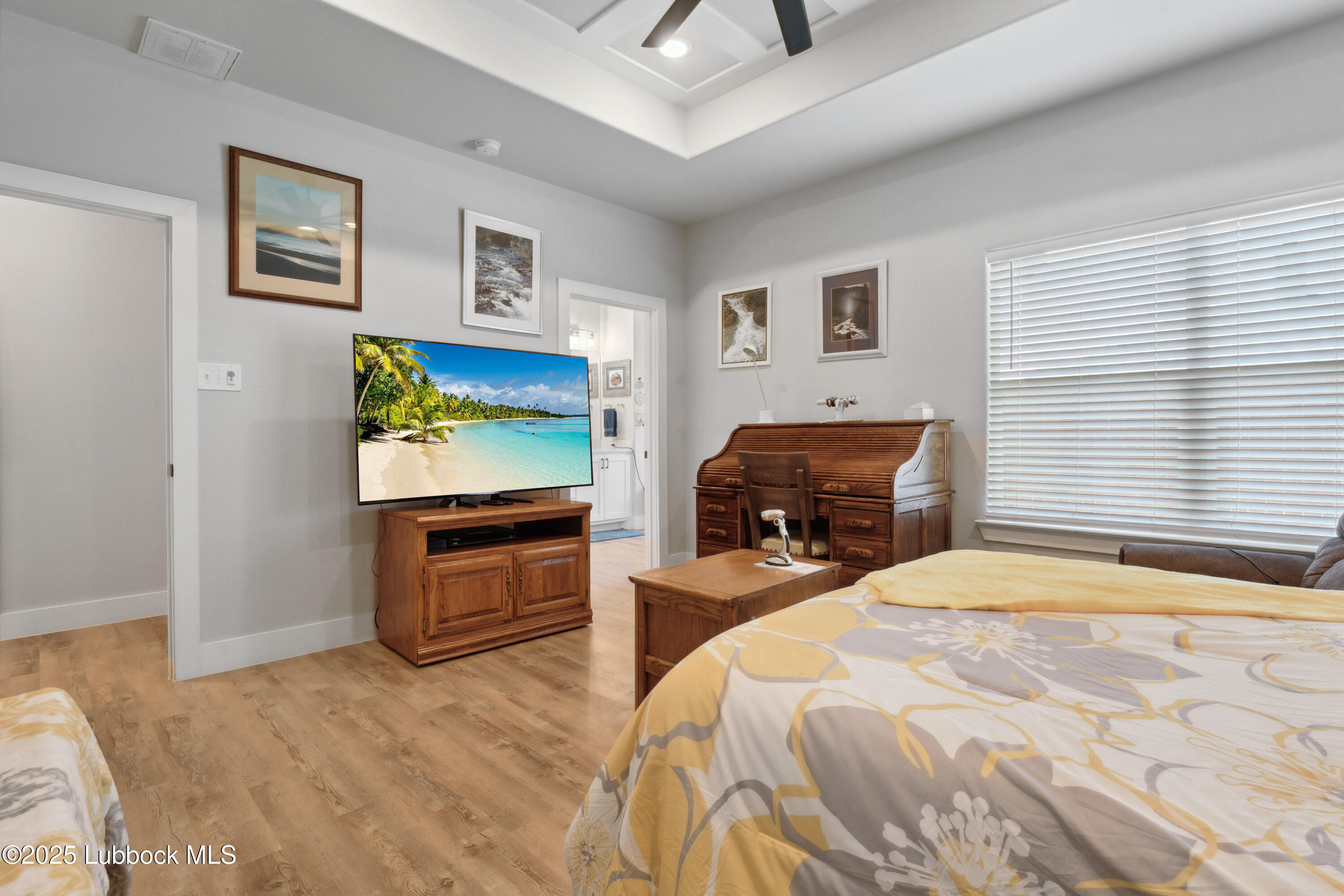 2915 137th Street Lubbock, TX 79423 - Photo 29 of 40 a bedroom with a bed and a flat screen tv