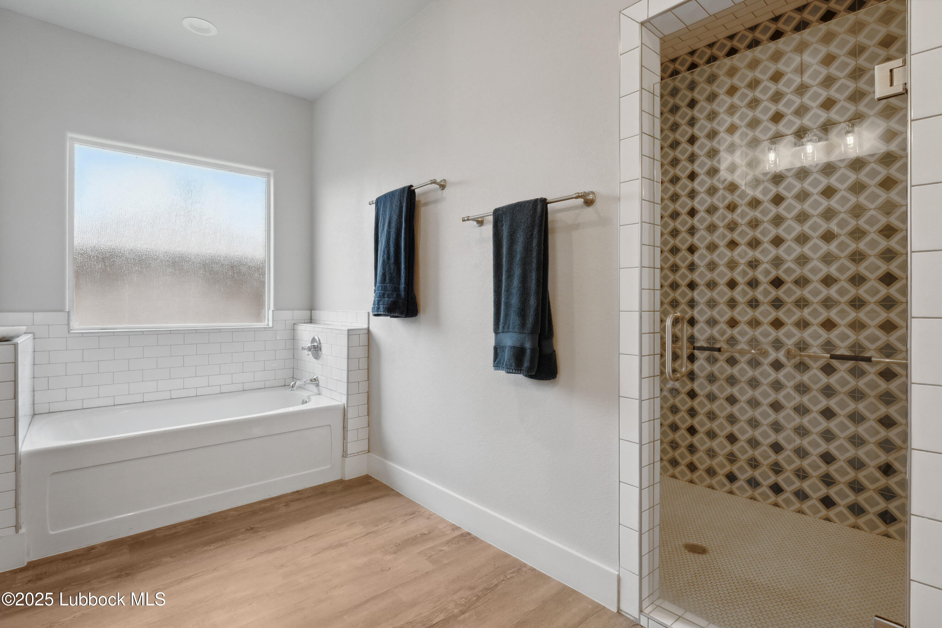 2915 137th Street Lubbock, TX 79423 - Photo 32 of 40 a bathroom with a bathtub and a shower