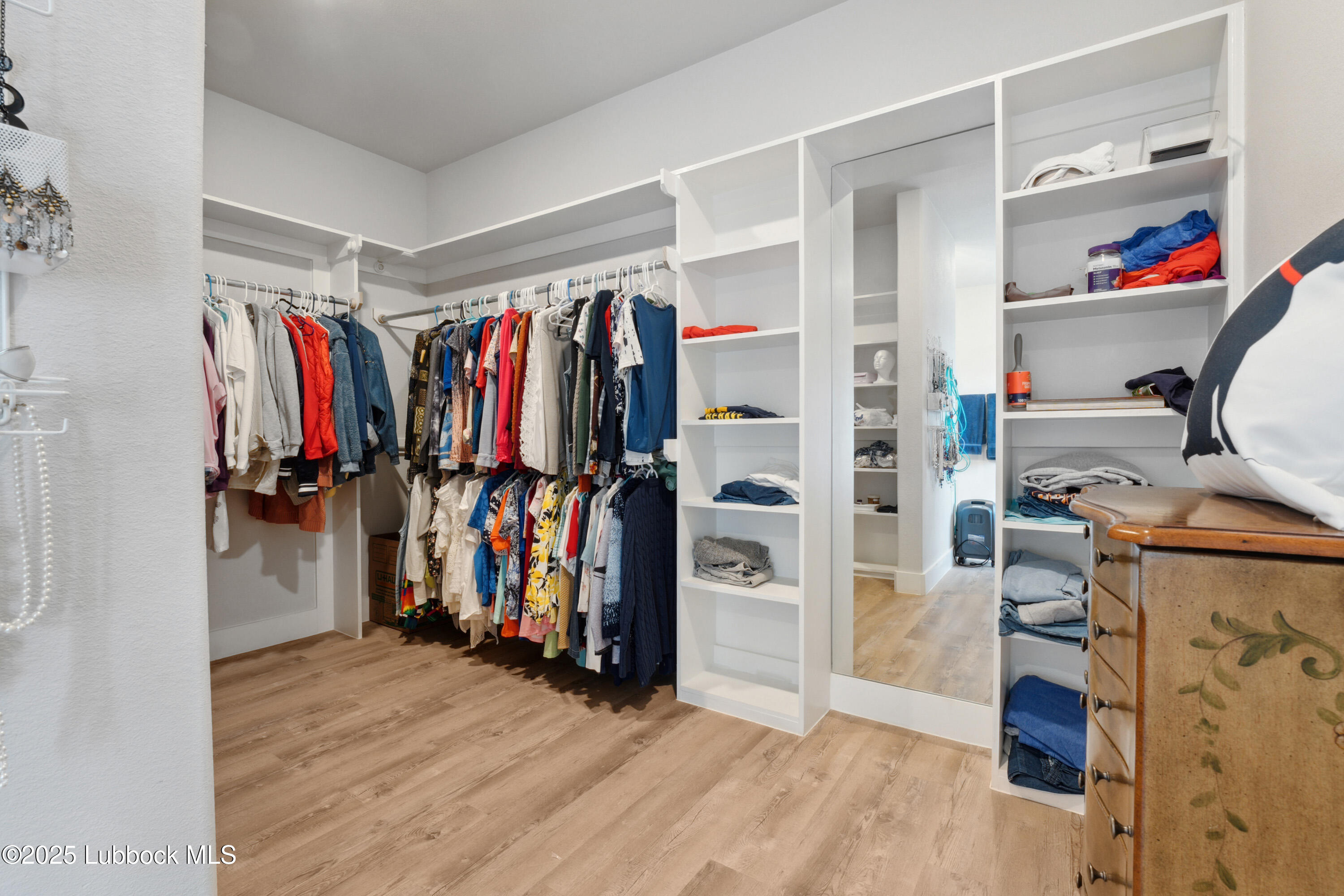 2915 137th Street Lubbock, TX 79423 - Photo 35 of 40 a view of walk in closet with clothes and shoes