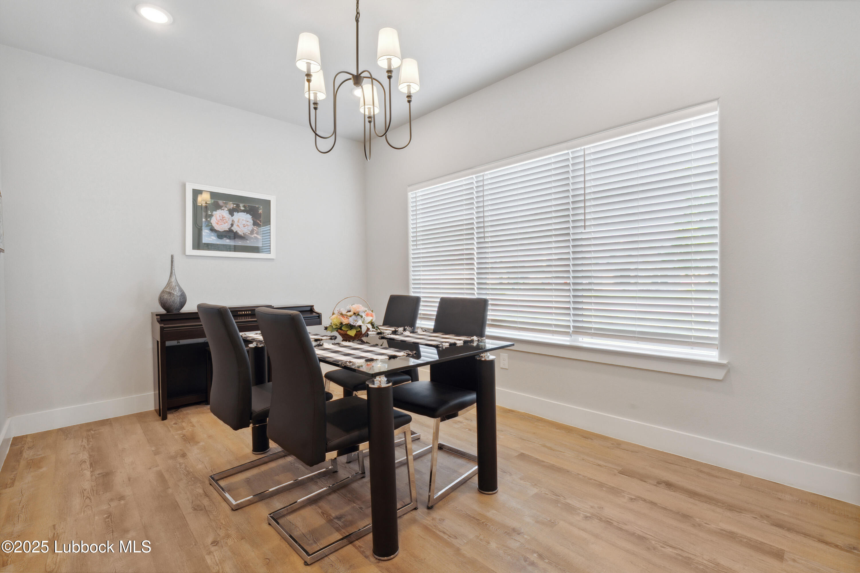 2915 137th Street Lubbock, TX 79423 - Photo 5 of 40 a view of a workspace with furniture and a window