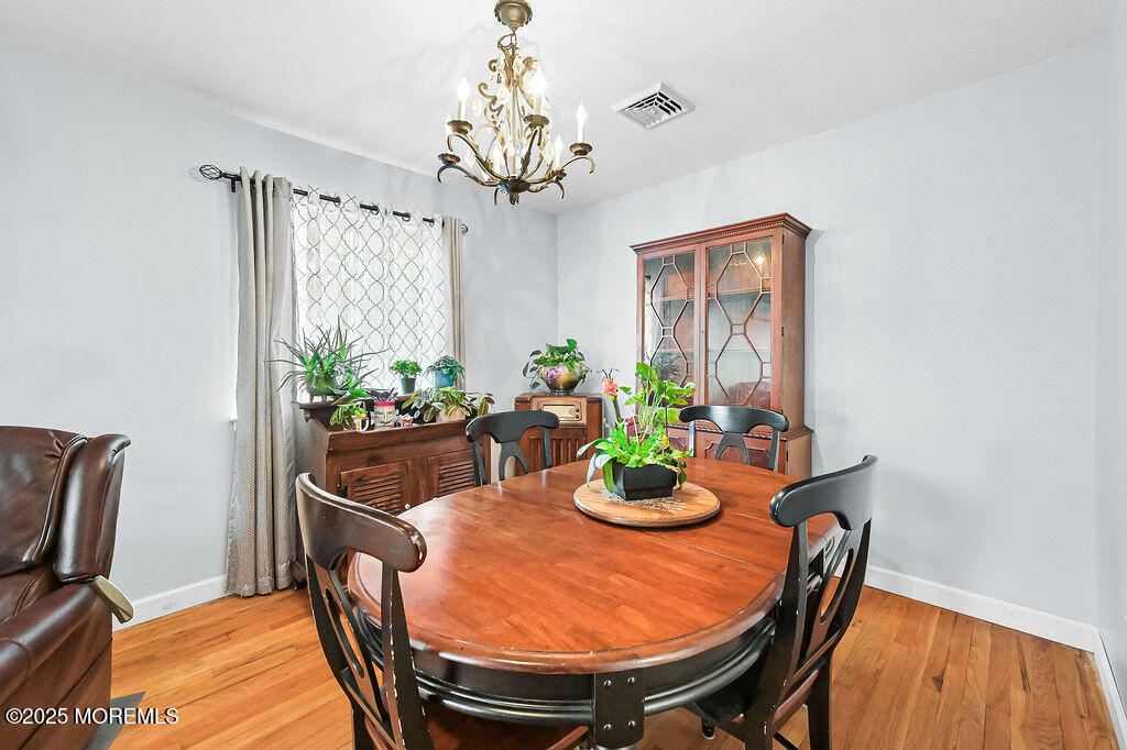 9 Tralee Road Hazlet, NJ 07730 - Photo 11 of 40 a dining room with furniture potted plants and wooden floor