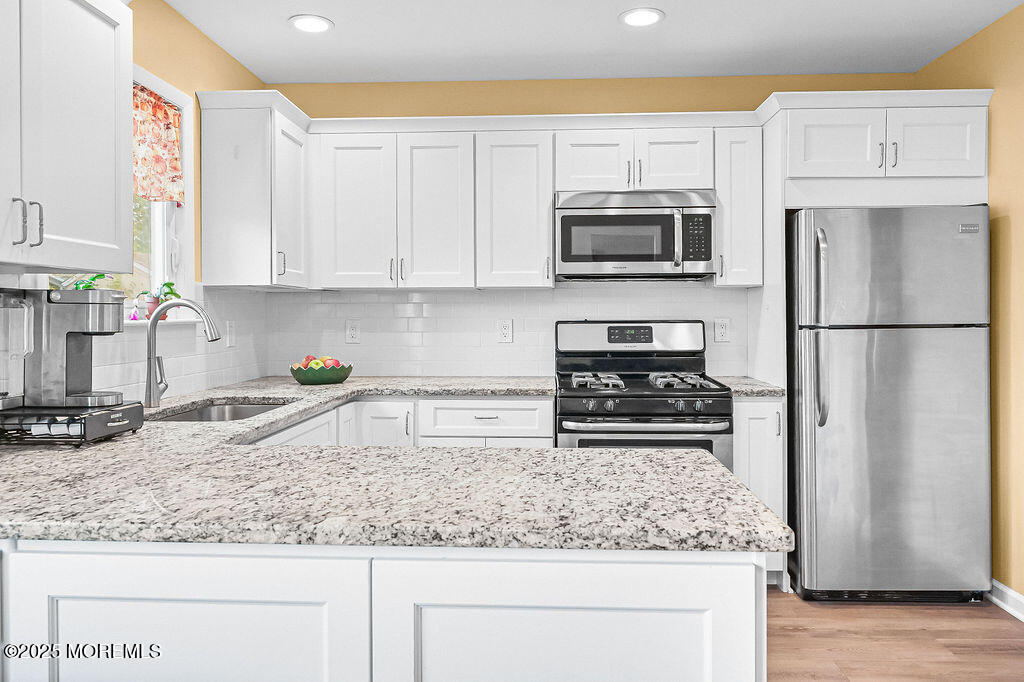 9 Tralee Road Hazlet, NJ 07730 - Photo 15 of 40 a kitchen with stainless steel appliances granite countertop a refrigerator sink and stove