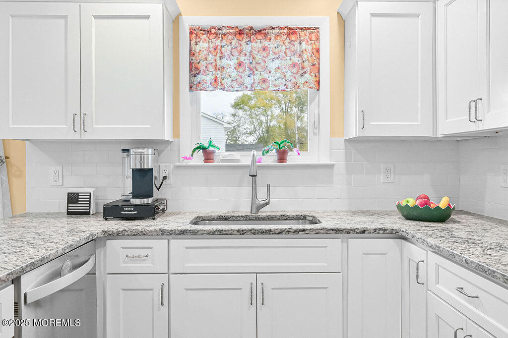 9 Tralee Road Hazlet, NJ 07730 - Photo 16 of 40 a kitchen with granite countertop white cabinets and a window