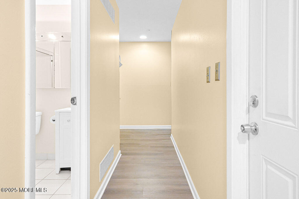 9 Tralee Road Hazlet, NJ 07730 - Photo 19 of 40 a view of a hallway with wooden floor and a bathroom