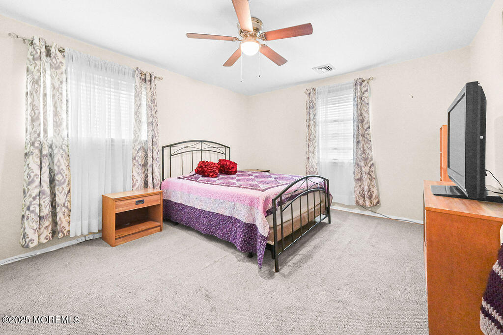 9 Tralee Road Hazlet, NJ 07730 - Photo 20 of 40 a bedroom with a bed and a flat tv screen on dresser