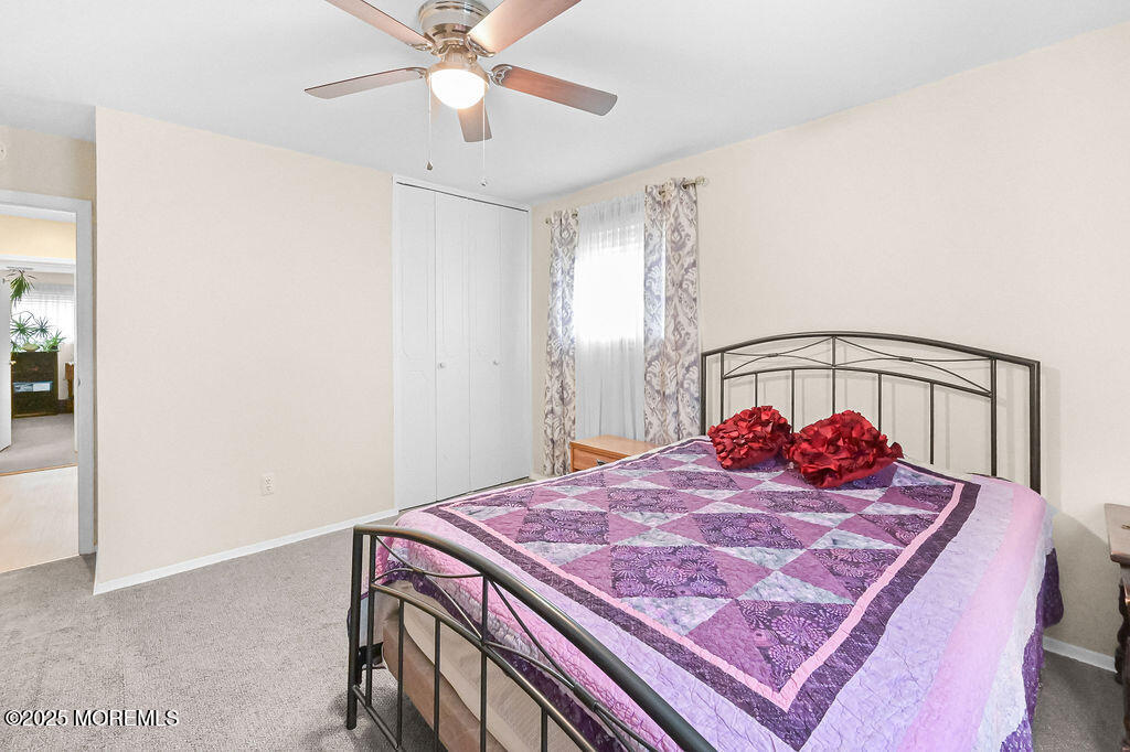 9 Tralee Road Hazlet, NJ 07730 - Photo 21 of 40 a bedroom with a bed and a chandelier
