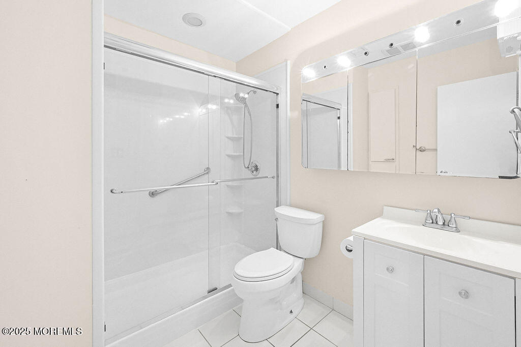 9 Tralee Road Hazlet, NJ 07730 - Photo 24 of 40 a bathroom with a toilet a sink and a mirror