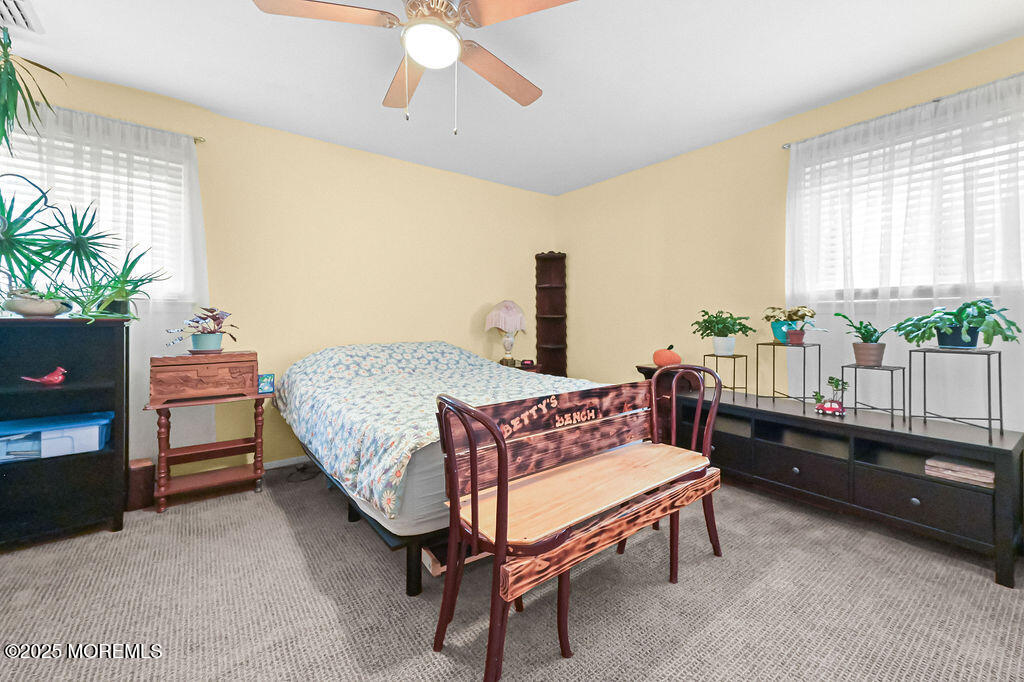 9 Tralee Road Hazlet, NJ 07730 - Photo 25 of 40 a bedroom with a bed and a chandelier