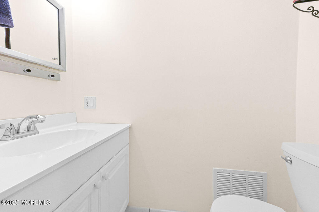 9 Tralee Road Hazlet, NJ 07730 - Photo 27 of 40 a bathroom with a sink and a mirror