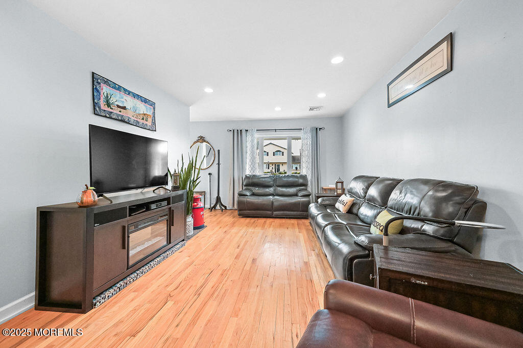 9 Tralee Road Hazlet, NJ 07730 - Photo 10 of 40 a living room with furniture and a flat screen tv