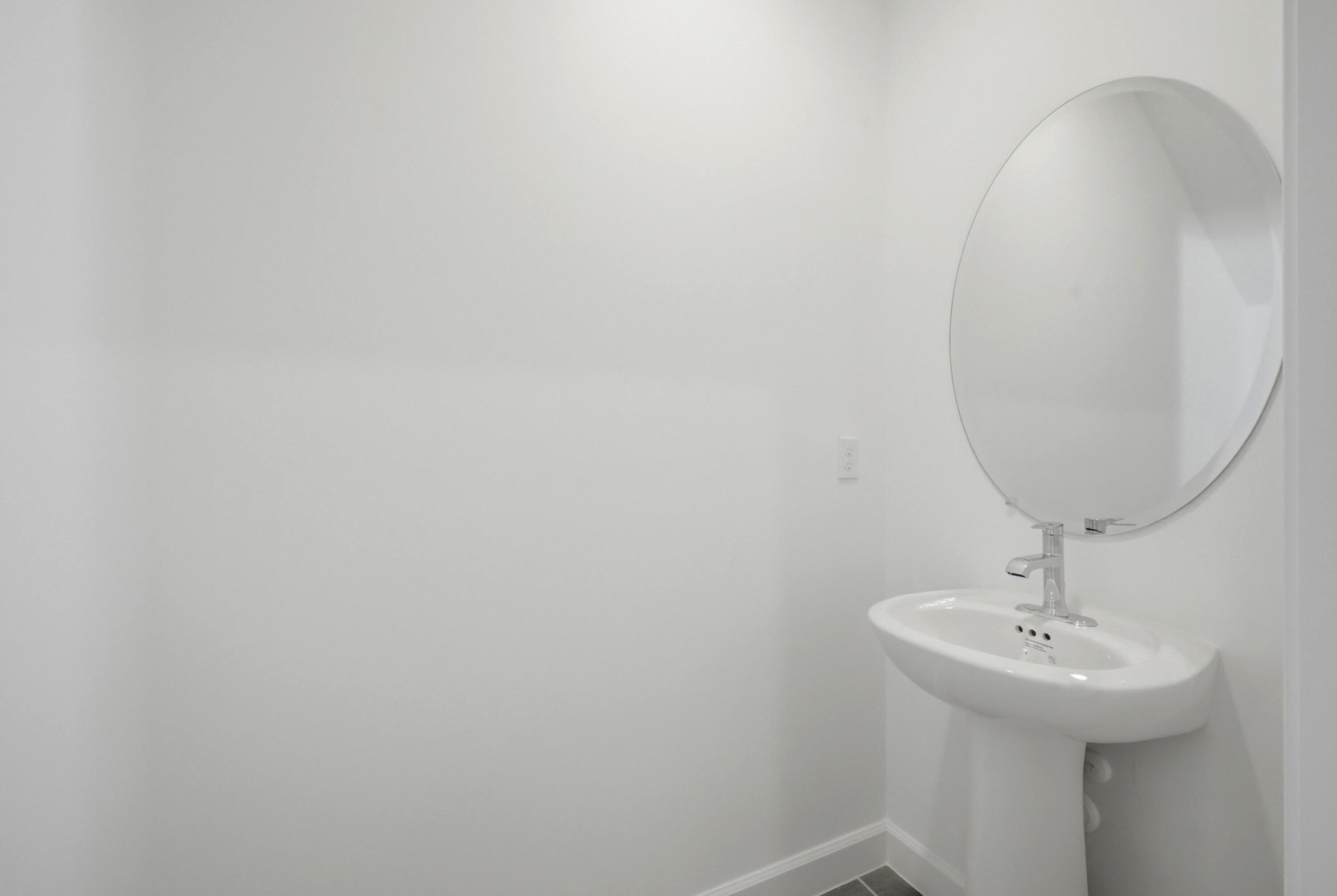 19568 Whispering Creek Road Loxahatchee, FL 33470 - Photo 13 of 30 a bathroom with a sink and mirror